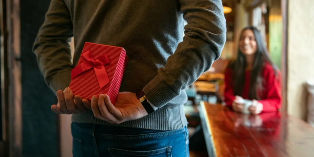 Man surprising partner with a gift