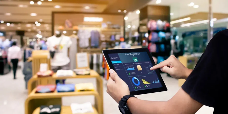 Manager using digital tablet on blurred store as background