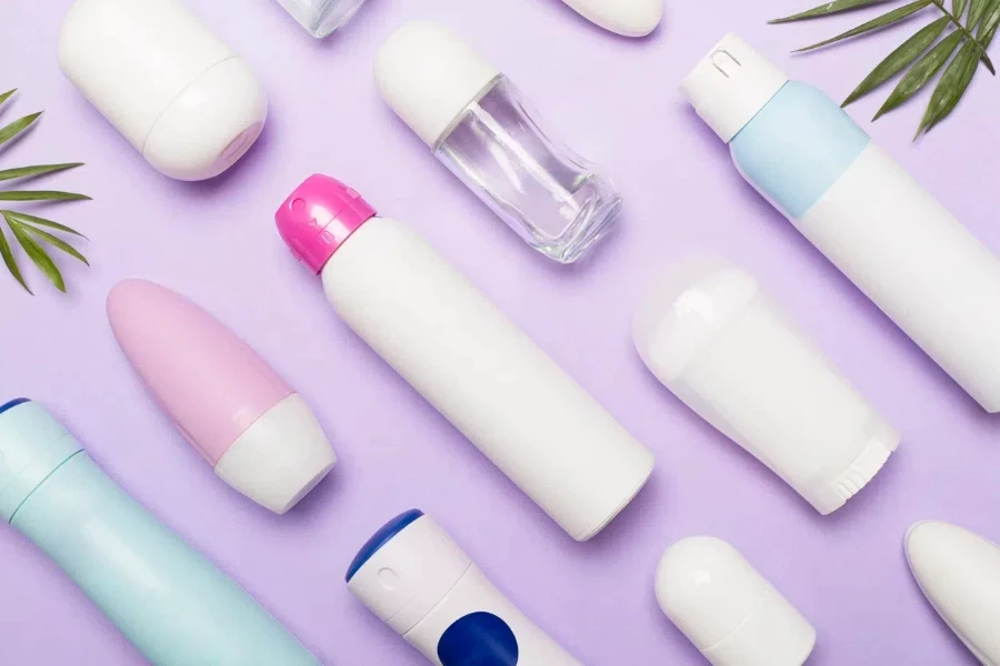 Many different deodorants on color background