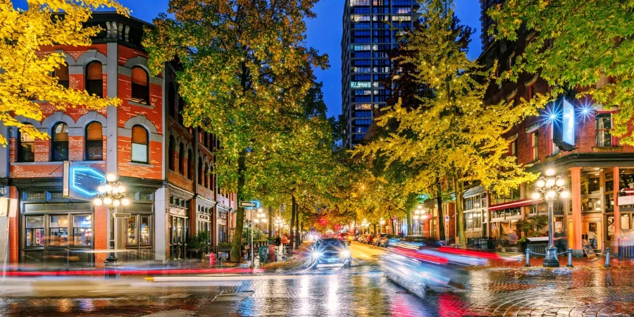 Night on the street in the old part of the big city with the lights of storefronts and shops