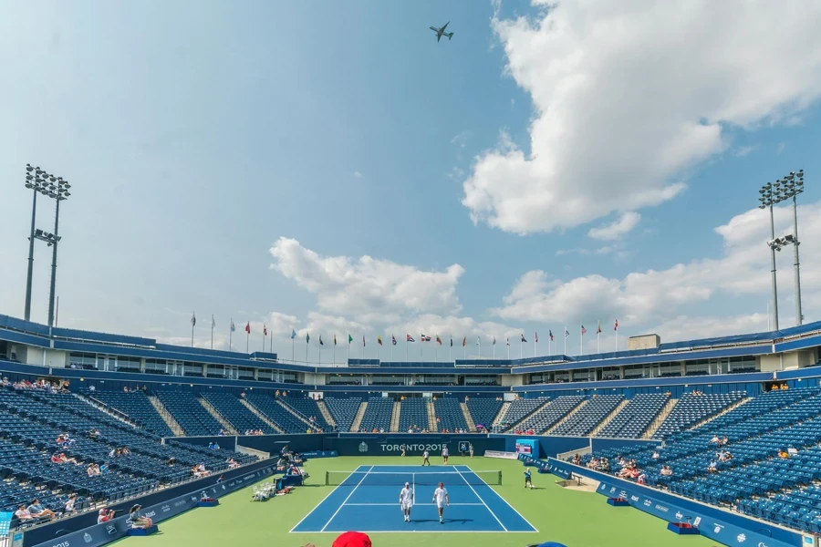 People Standing on Blue and Green Tennis Court