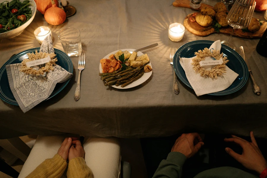 People seated at a decorated dining table with food served