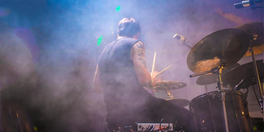 Performing Drummer Surrounded by Fogs