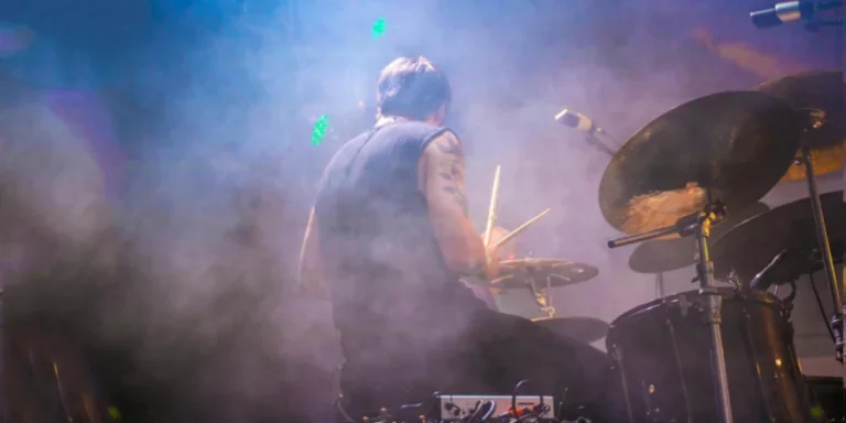 Performing Drummer Surrounded by Fogs