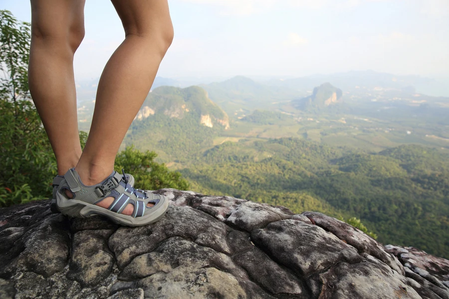 Person standing in walking sandals with arch support