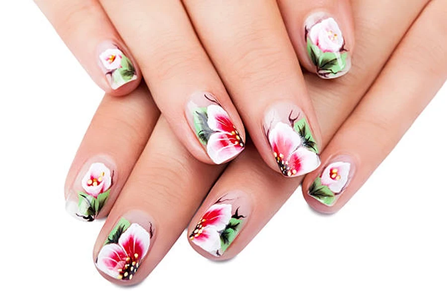 Pink flowers with green leaves painted on fingernails