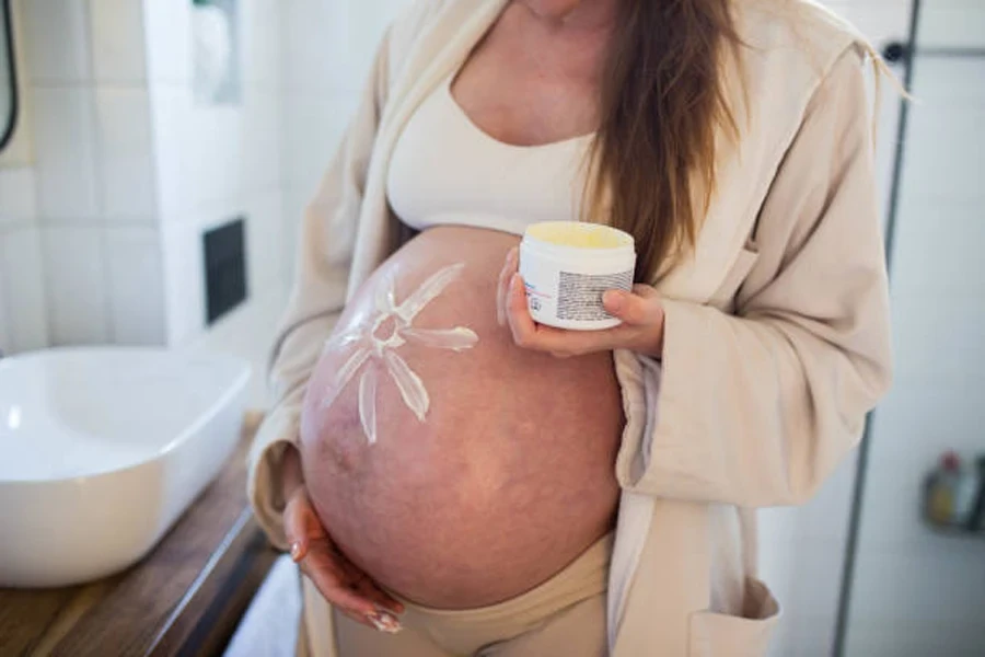 Pregnant Women Putting Anti Stretch Creme on Her Belly