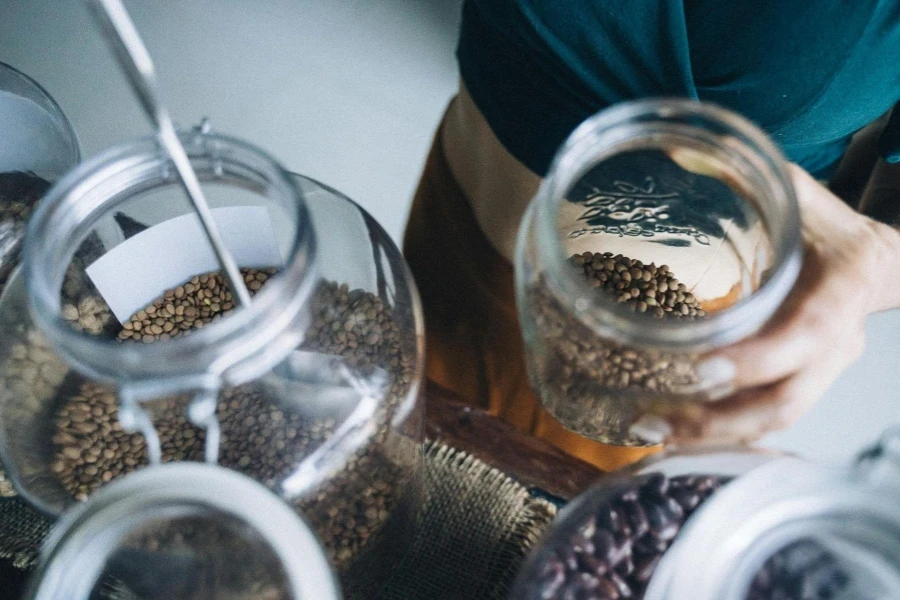 Saleswoman Packing Mustard Seeds into a Jar