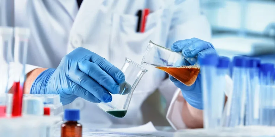 Scientist mixing chemical liquids in the chemistry lab