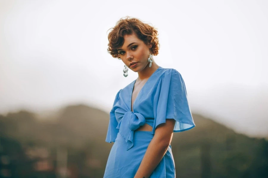 Selective focus photography of woman in blue crop top standing