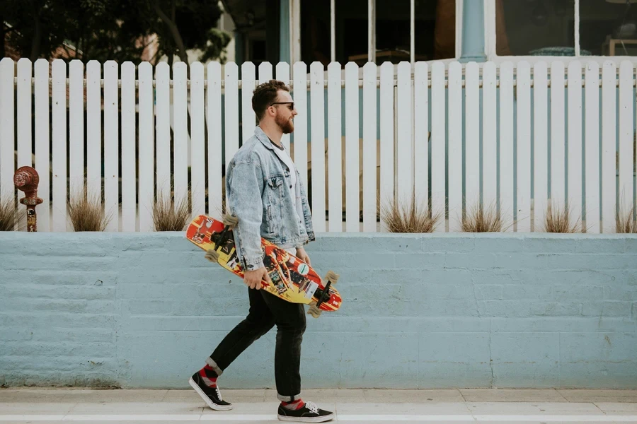 Skater carrying skateboard