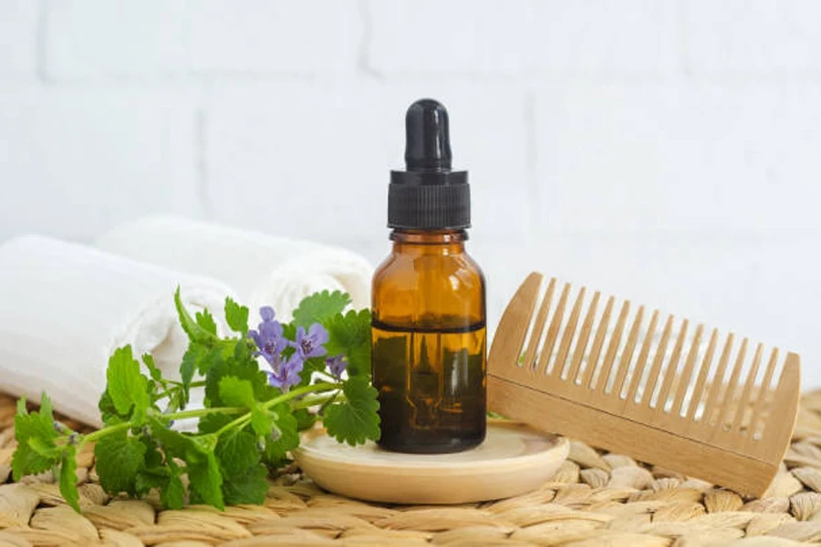 Small Bottle with Hair Serum and Wooden Hairbrush