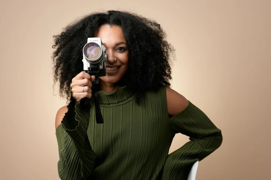 Smiling Woman Sitting with Camera