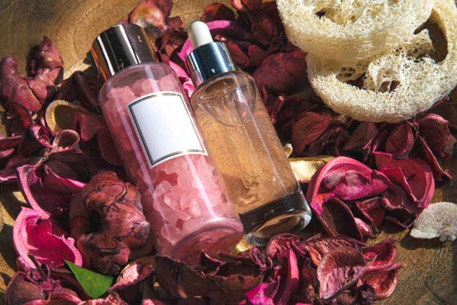 Spa Composition with Facial Care Products Among Rose Petals