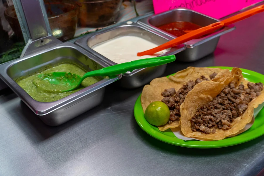 Tacos on Plate and Sauces in Trays