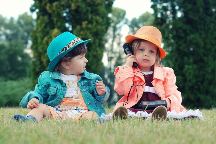 Two children sitting on the grass