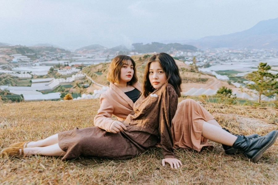 Two women sitting on hill