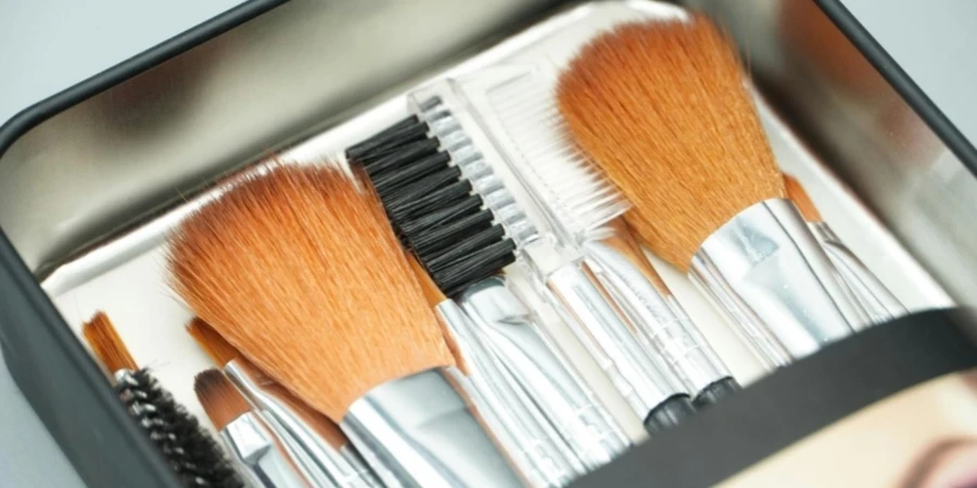 Various Makeup Brushes in a Metal Box