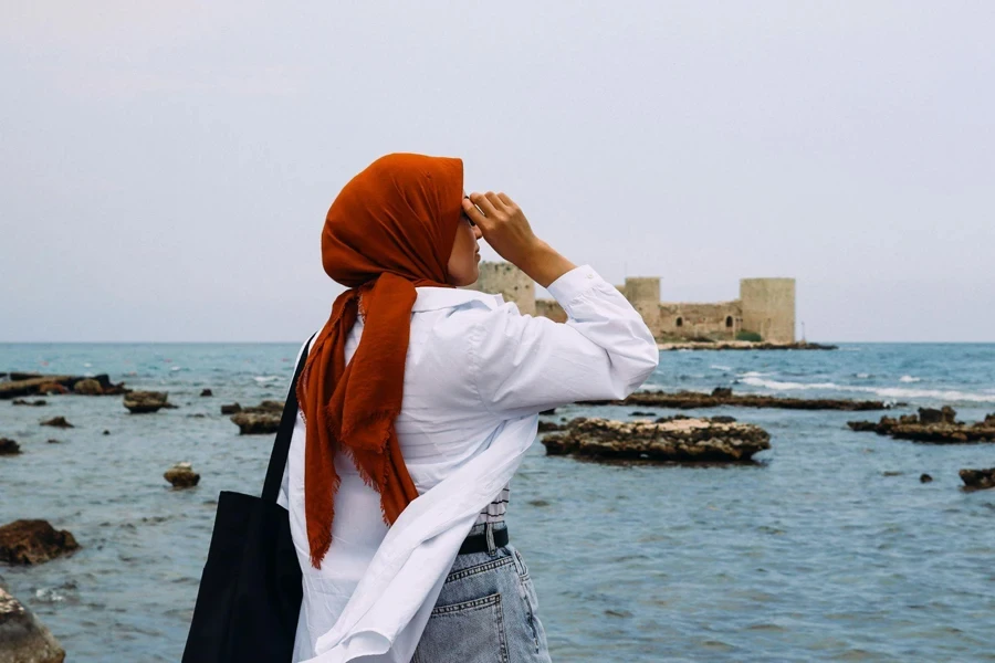 Woman Admiring Seaside Fortress Landscape