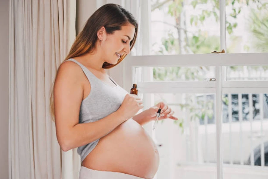 Woman Applying Oil to Her Pregnant Belly