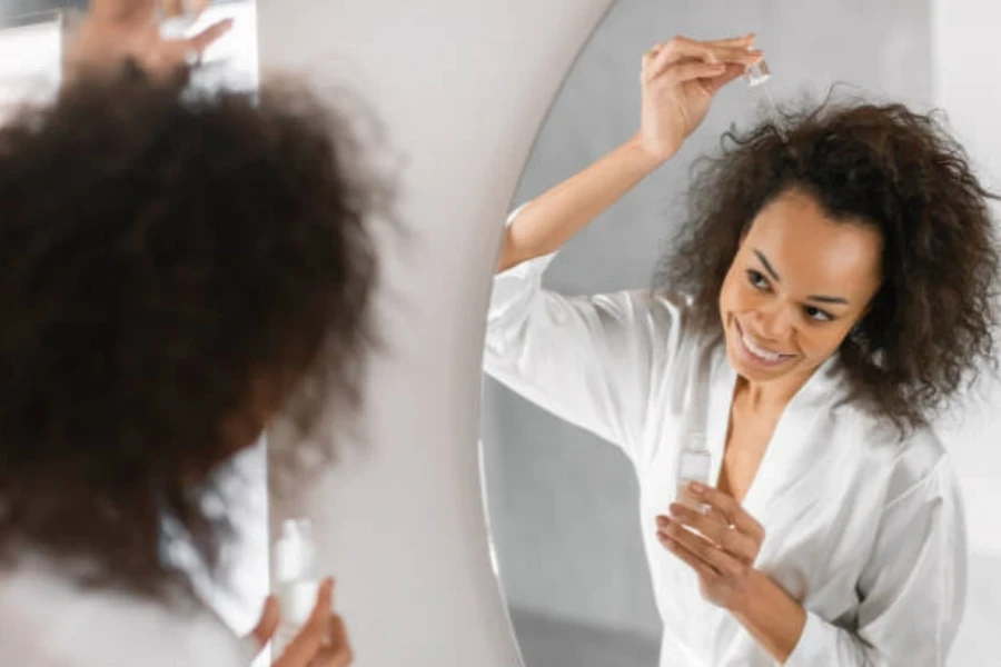 Woman Applying Serum to Hair