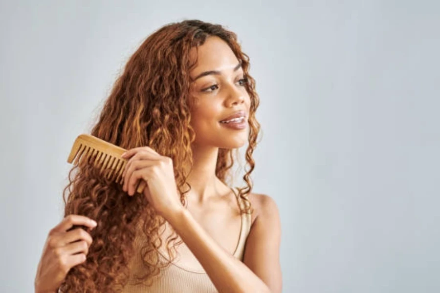 Woman Brushing Her Curly Hair in Bathroom