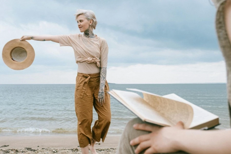 Woman Holding Hat on Beach