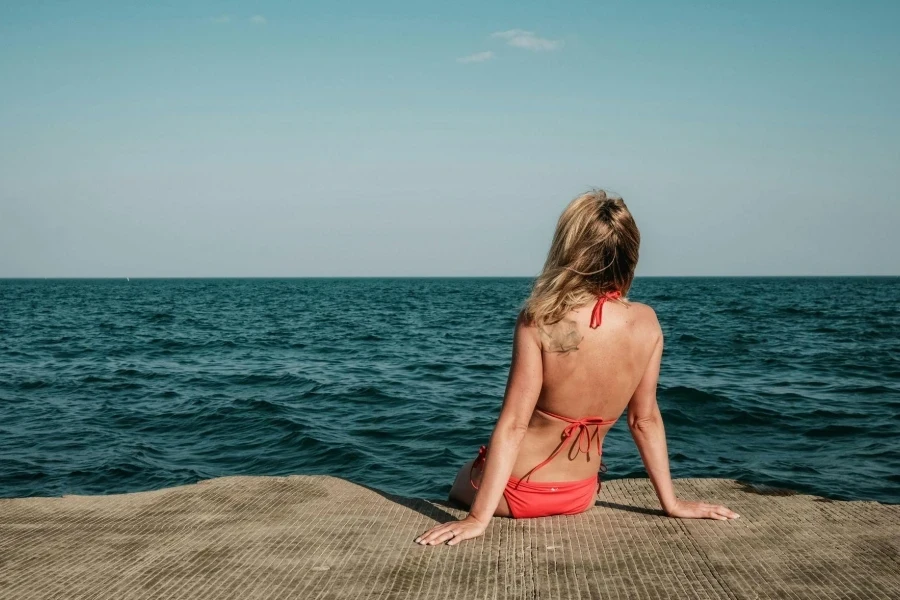 Woman Relaxing by the Ocean on a Sunny Day