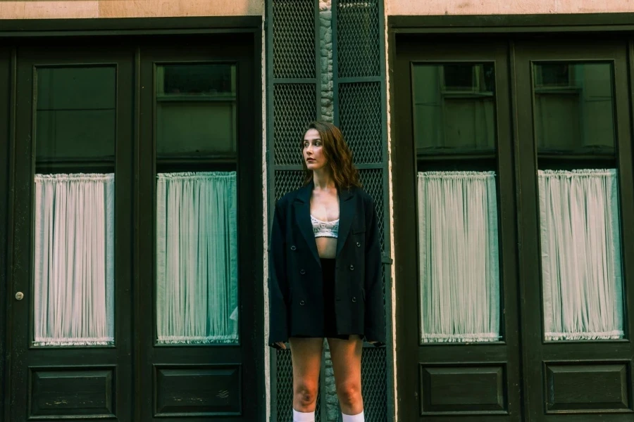 Woman Standing in Black Jacket and Bra