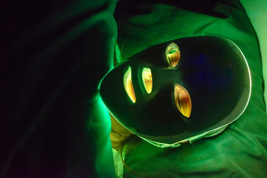 Woman enjoying a LED mask therapy session