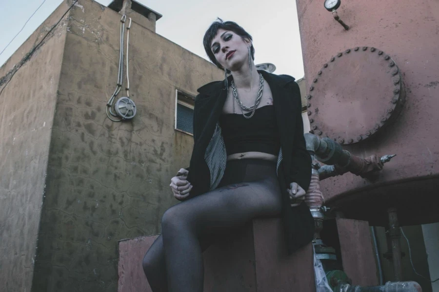 Woman in Black Crop Top Sitting on Brown Chair