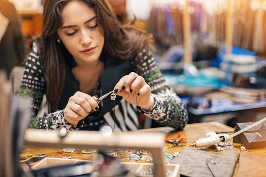 Woman making jewelry in her studio