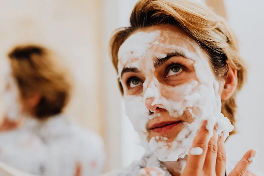 Woman massaging her face with cleansing foam