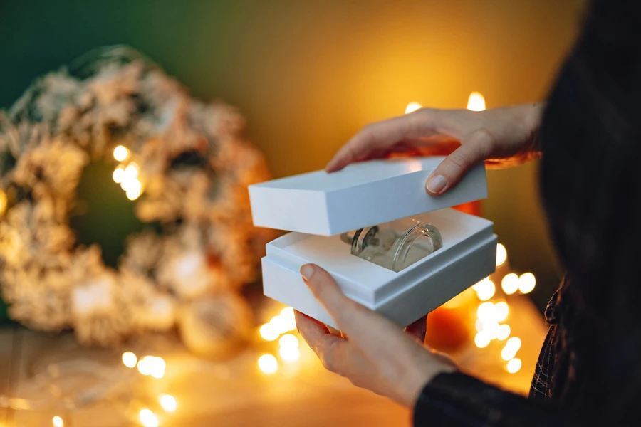 Woman opening a perfume gift