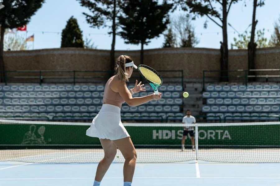 Woman playing tennis in a white high-waisted A-line skirt