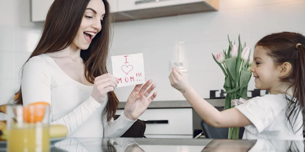 Woman receiving Mother's Day card from her daughter