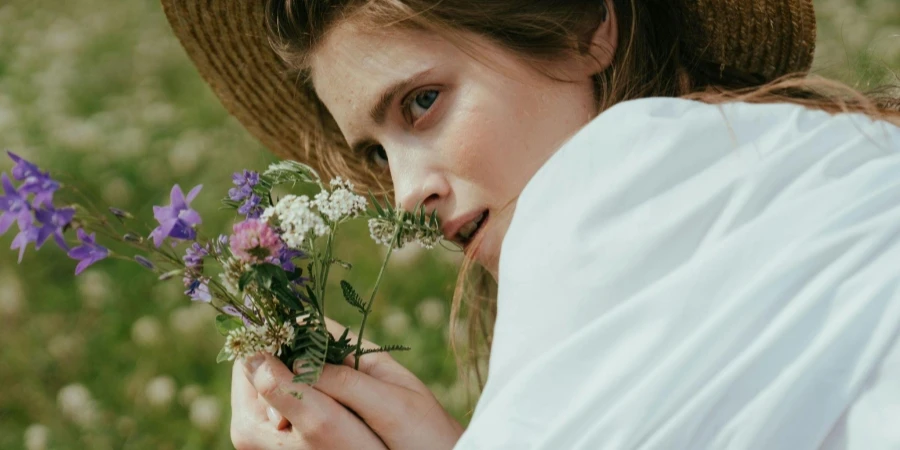 Woman smelling a bunch of flowers