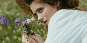 Woman smelling a bunch of flowers