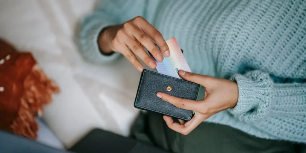 Woman taking a card out of her wallet