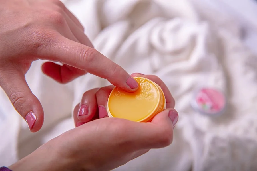 Woman taking a scoop of a jelly beauty product