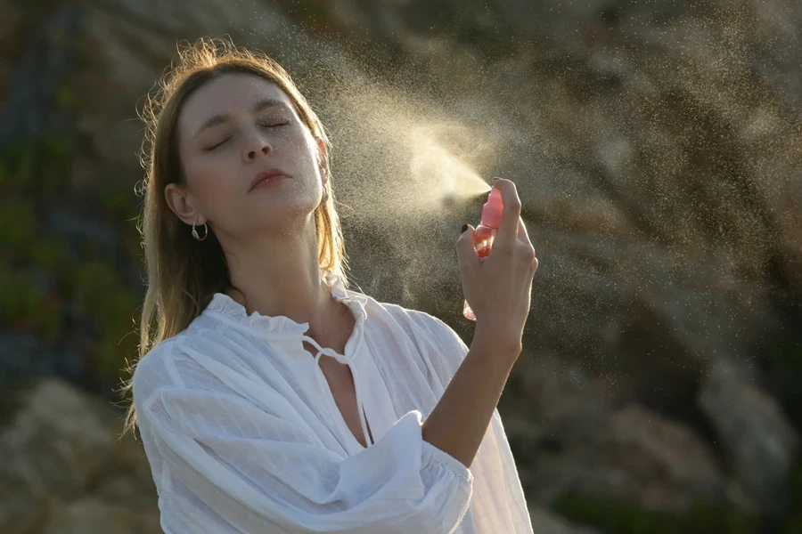 Woman using facial mist on her face