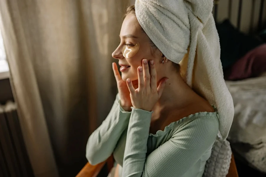 Woman using semi-transparent under eye patches