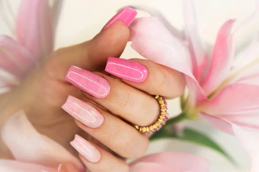 Woman wearing French manicure with pink flower petals