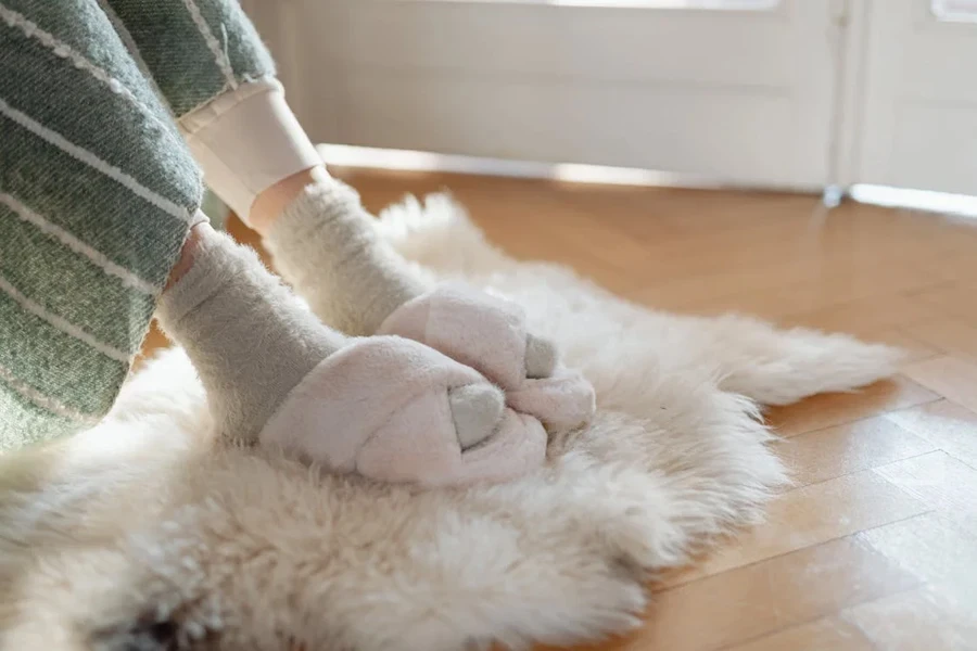 Woman wearing comfy white slip-on slippers