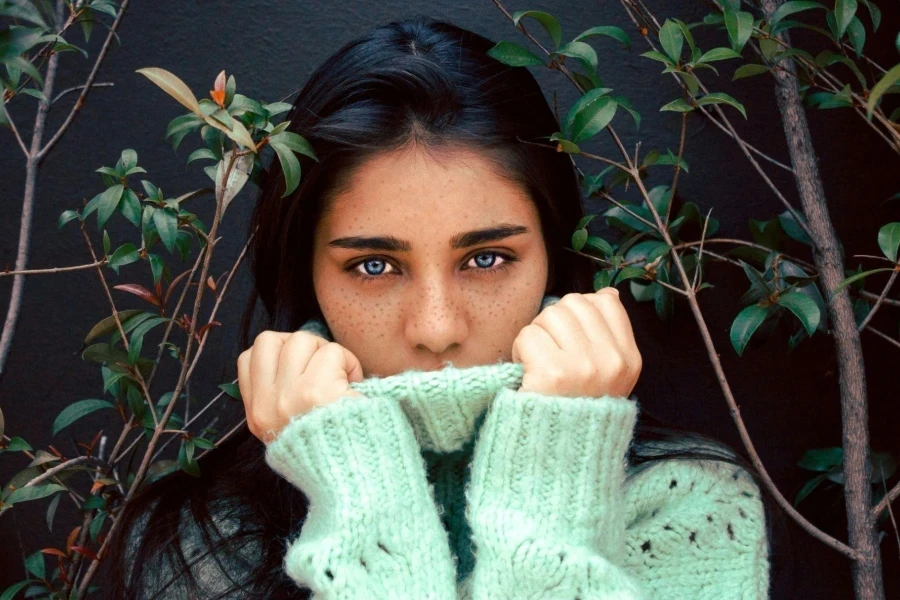 Woman wearing green knitted sweater