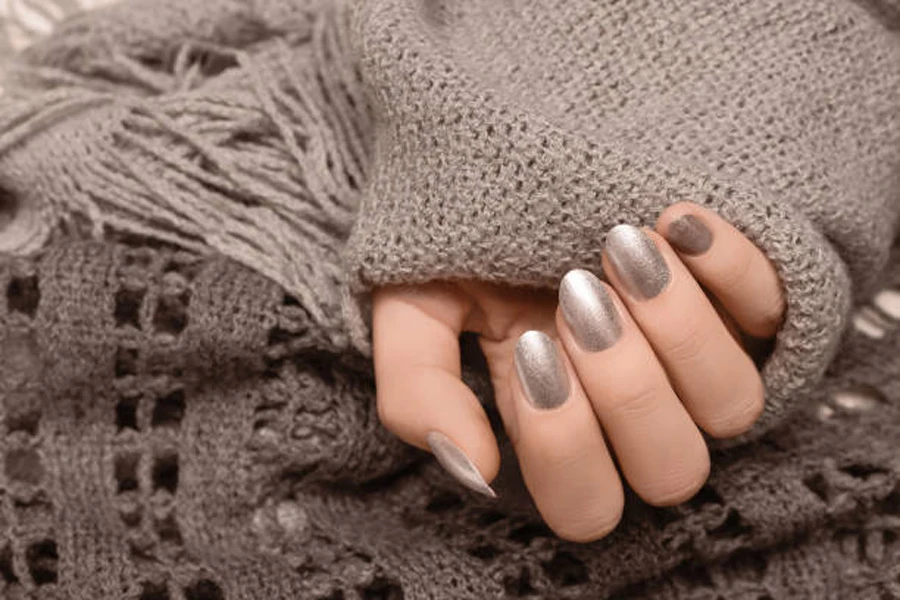 Woman wearing sweater with silver metallic nails for fall