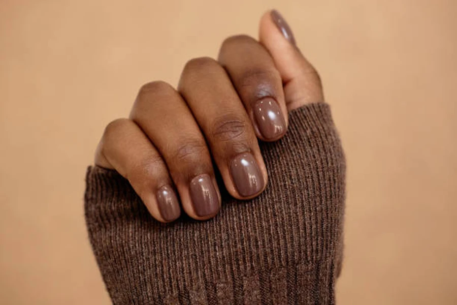 Woman with brown neutral colored nails for the fall