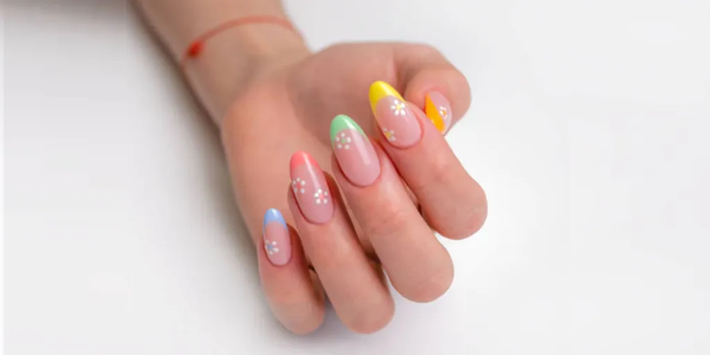 Woman with colorful spring-themed nail tip art