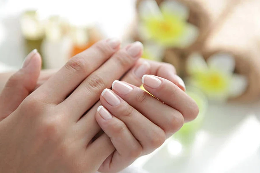 Woman with traditional white French tip nail design