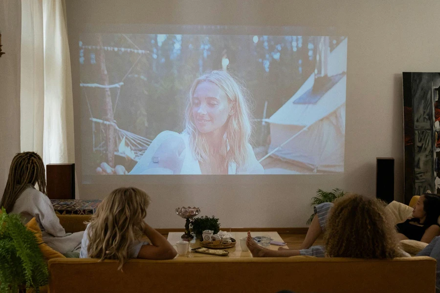 Women Sitting on the Sofa while Watching a Movie